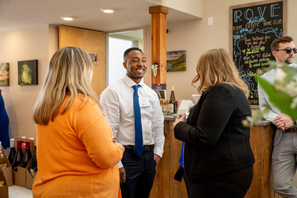 Three alums talking at the event.